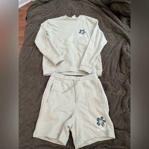 Set! Crewneck sweatshirt with sweat shorts. It is a light/mint green color.